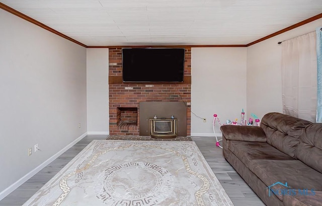 living room featuring a wood stove, hardwood / wood-style floors, and ornamental molding