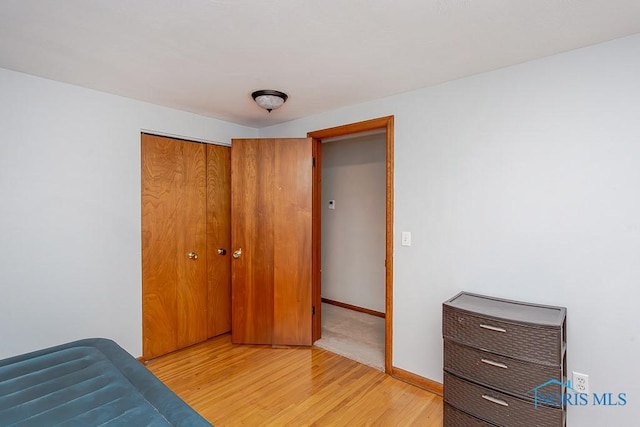 bedroom featuring a closet and light hardwood / wood-style flooring