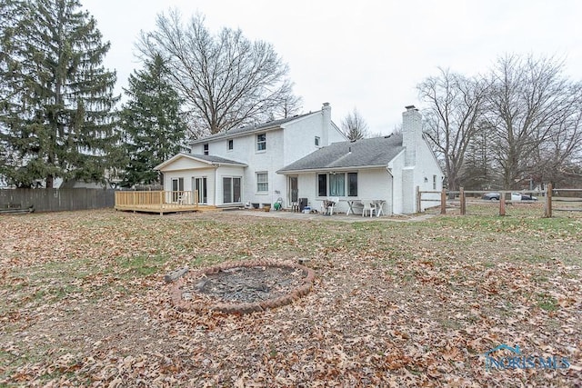 back of house featuring a patio area and a deck