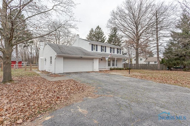 front of property featuring a porch and a garage