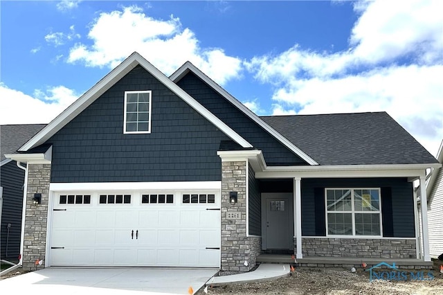2261 Falling Waters Ln, Perrysburg, OH 43551 - craftsman inspired home with a garage, roof with shingles, driveway, and stone siding