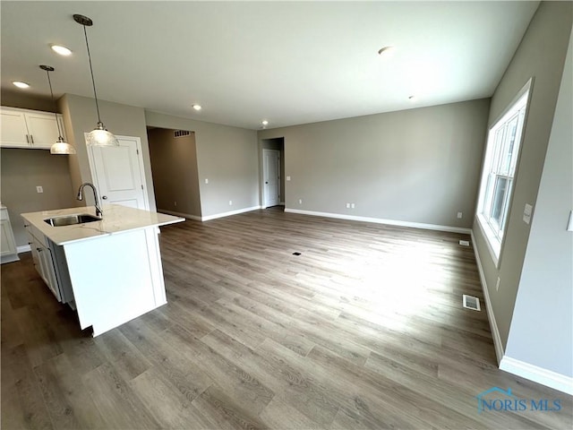 2261 Falling Waters Ln, Perrysburg, OH 43551 - kitchen with visible vents, baseboards, a sink, and wood finished floors