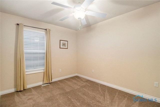 carpeted empty room featuring ceiling fan