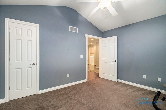 unfurnished bedroom featuring carpet, ceiling fan, and vaulted ceiling