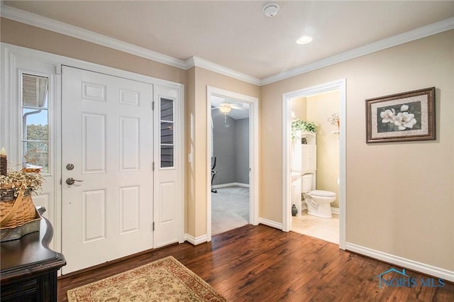 entrance foyer featuring crown molding and dark hardwood / wood-style flooring