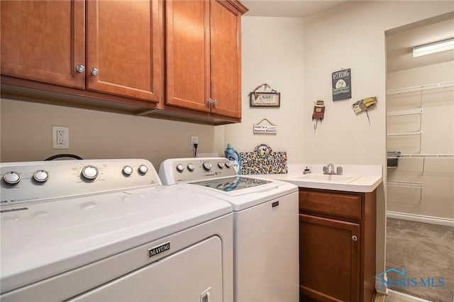 laundry area featuring washer and dryer, carpet, cabinets, and sink