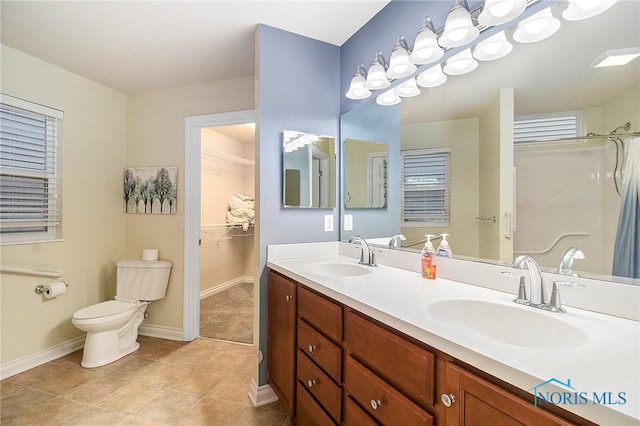 bathroom with tile patterned floors, vanity, and toilet