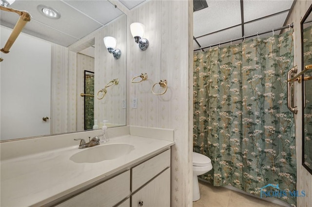 bathroom with tile patterned floors, vanity, toilet, and walk in shower