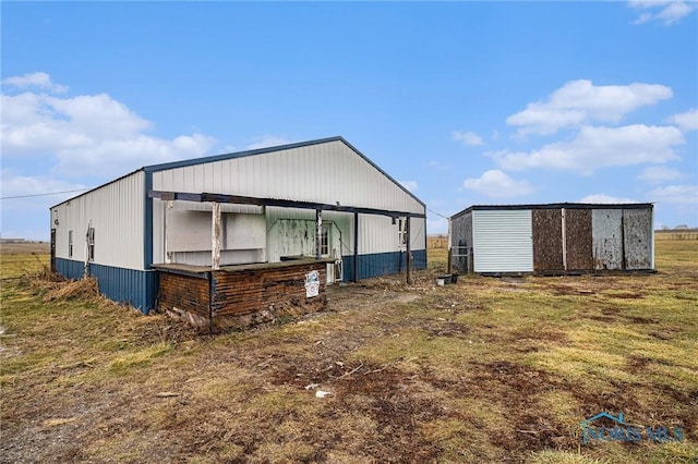 view of home's exterior with an outbuilding