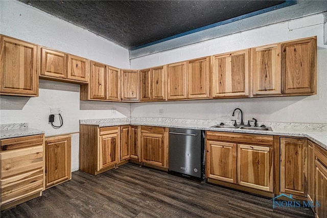 kitchen with dark hardwood / wood-style flooring, stainless steel dishwasher, and sink