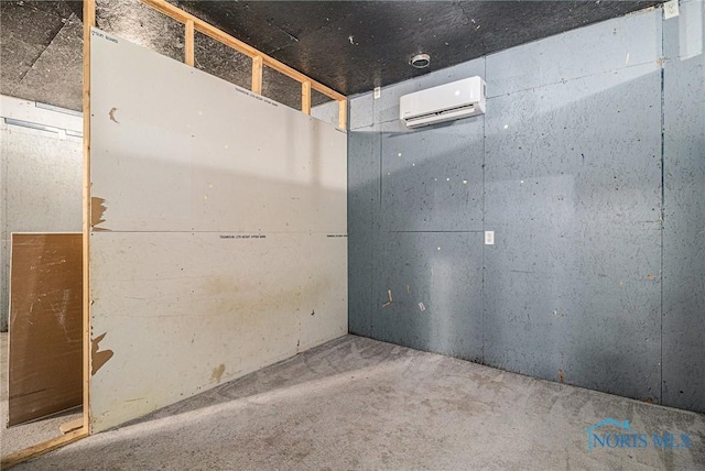 spare room with concrete flooring and a wall unit AC