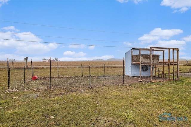 view of yard featuring a rural view and an outdoor structure