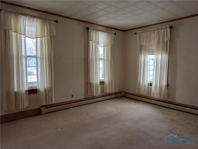 spare room featuring carpet flooring and baseboard heating