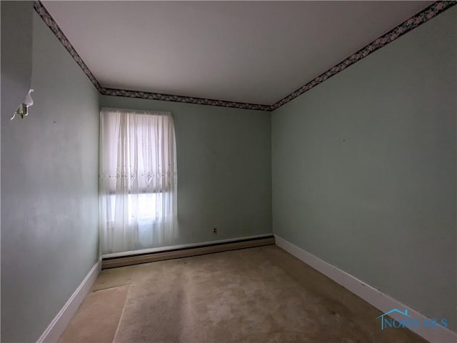 carpeted empty room featuring a baseboard radiator