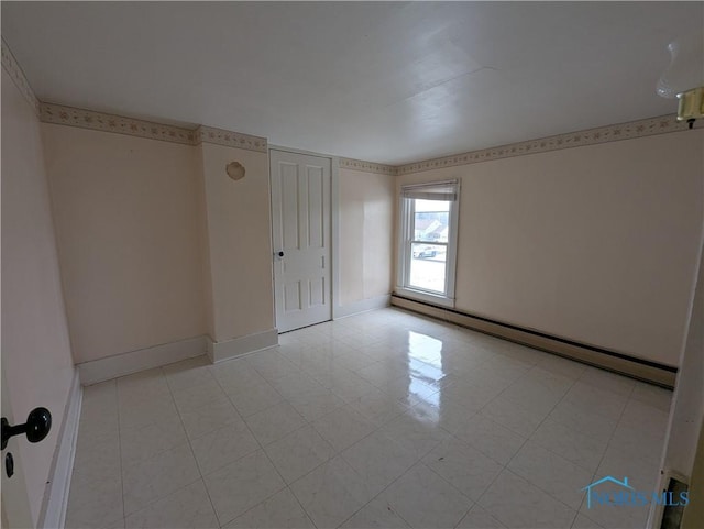 unfurnished room with a baseboard radiator