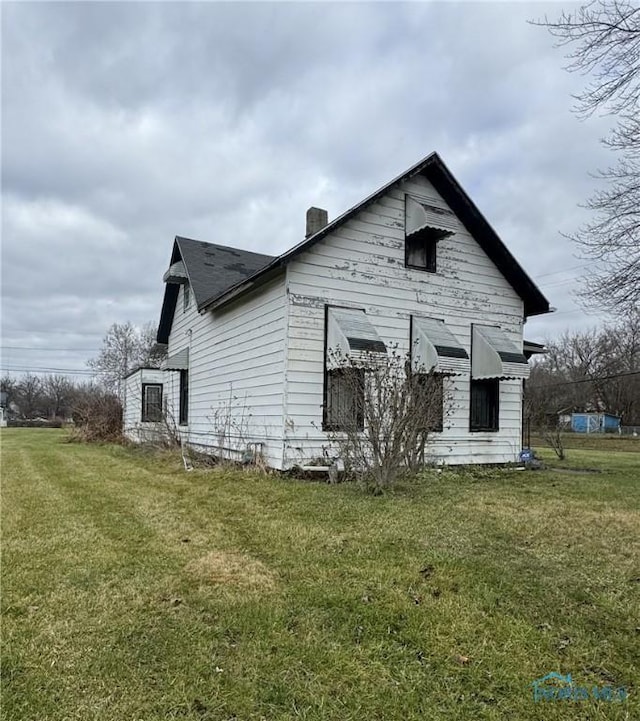 back of house with a lawn