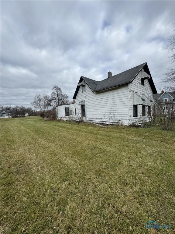 view of side of property with a lawn