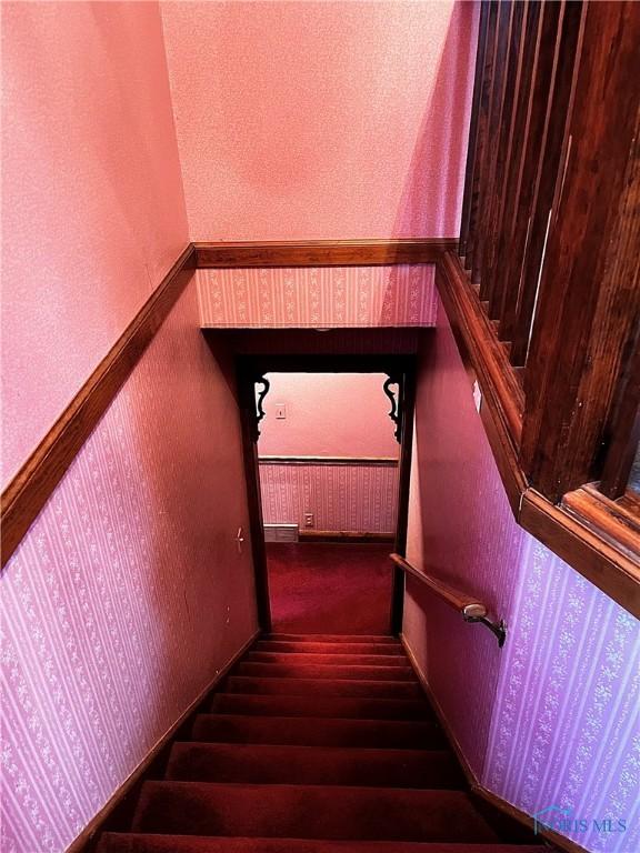 stairway featuring wood-type flooring