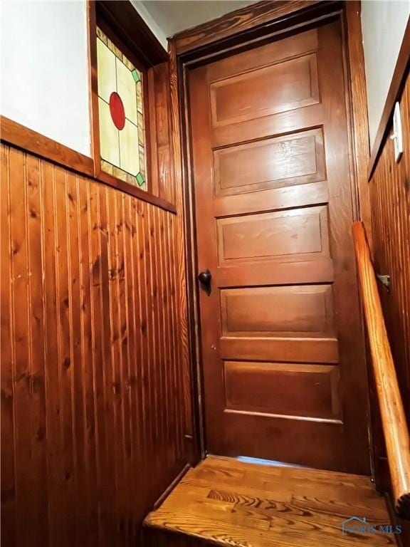 entryway featuring wood walls