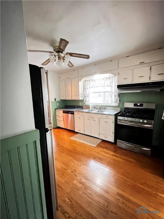 kitchen featuring white cabinets, appliances with stainless steel finishes, light hardwood / wood-style flooring, and sink