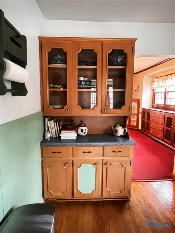 bar featuring dark hardwood / wood-style flooring