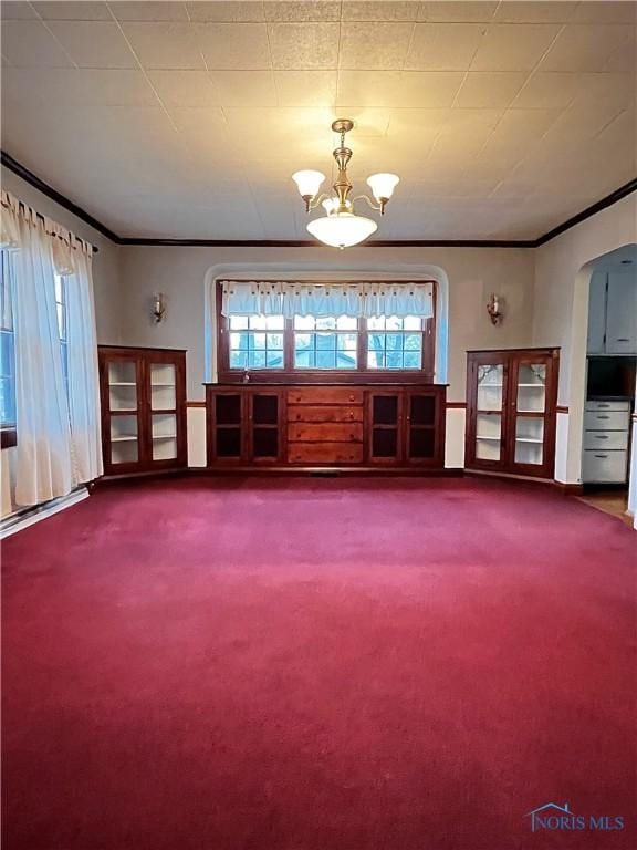 interior space with ornamental molding and a notable chandelier