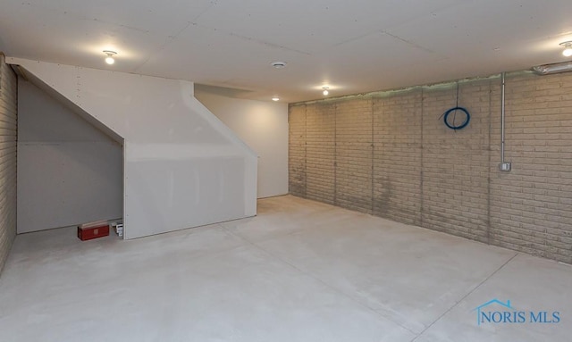 basement with brick wall