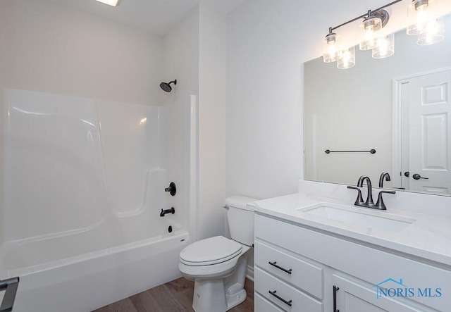 full bathroom featuring vanity,  shower combination, hardwood / wood-style flooring, and toilet