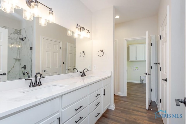 bathroom featuring a shower, vanity, and hardwood / wood-style flooring