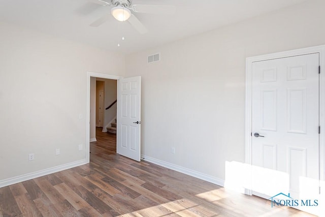 unfurnished room with ceiling fan and wood-type flooring