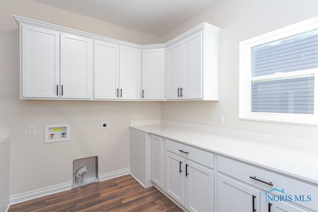 clothes washing area with hookup for a washing machine, dark hardwood / wood-style flooring, cabinets, and hookup for an electric dryer