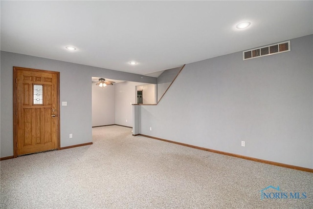 interior space featuring ceiling fan and light colored carpet