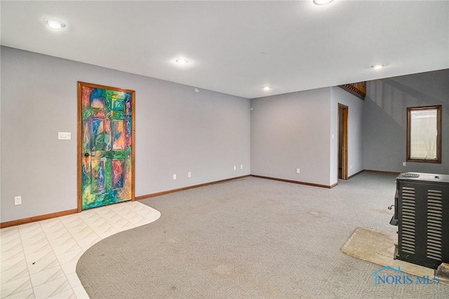 unfurnished room featuring light colored carpet