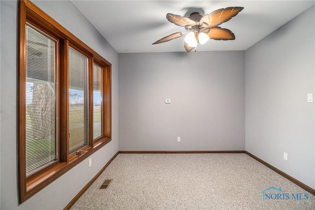 empty room featuring ceiling fan and carpet floors