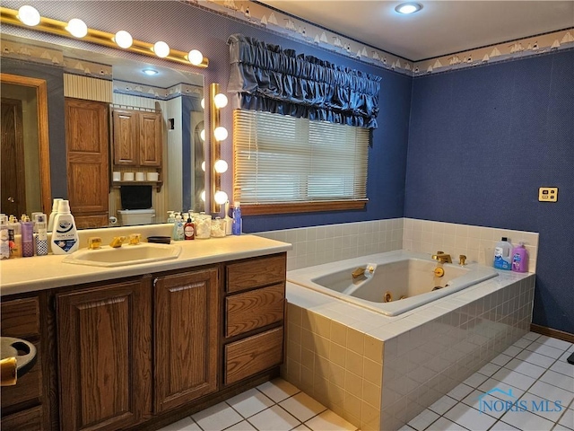 bathroom featuring tile patterned floors, vanity, and a relaxing tiled tub