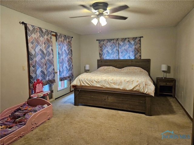 carpeted bedroom with a textured ceiling and ceiling fan