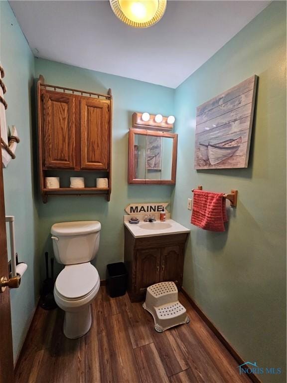 bathroom featuring hardwood / wood-style floors, vanity, and toilet