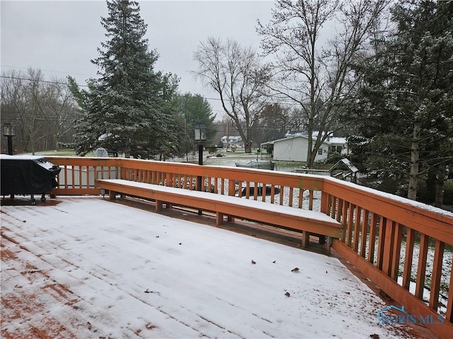 snow covered deck featuring grilling area