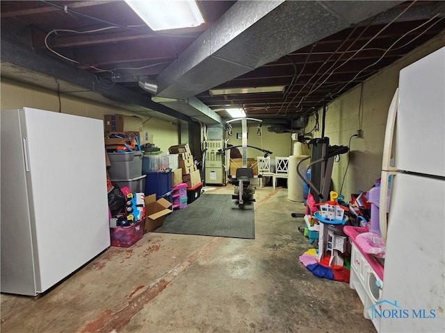 basement featuring white refrigerator