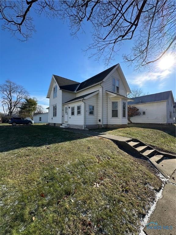 view of home's exterior with a yard