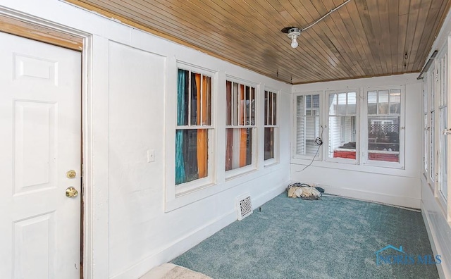 unfurnished sunroom with wooden ceiling