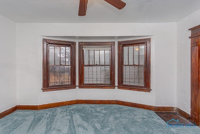 carpeted empty room featuring a textured ceiling