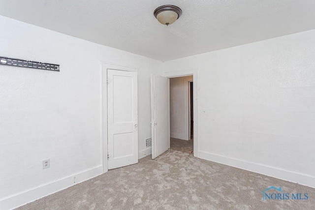 unfurnished room with light colored carpet