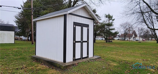 view of outbuilding with a yard