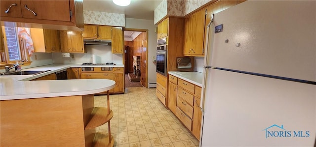 kitchen with dishwasher, sink, gas stovetop, white fridge, and oven