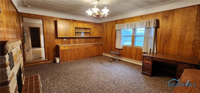 kitchen featuring dark colored carpet, a baseboard radiator, and wooden walls