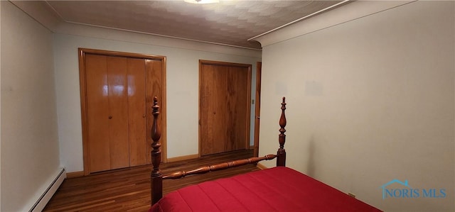 unfurnished bedroom featuring dark wood-type flooring and a baseboard radiator