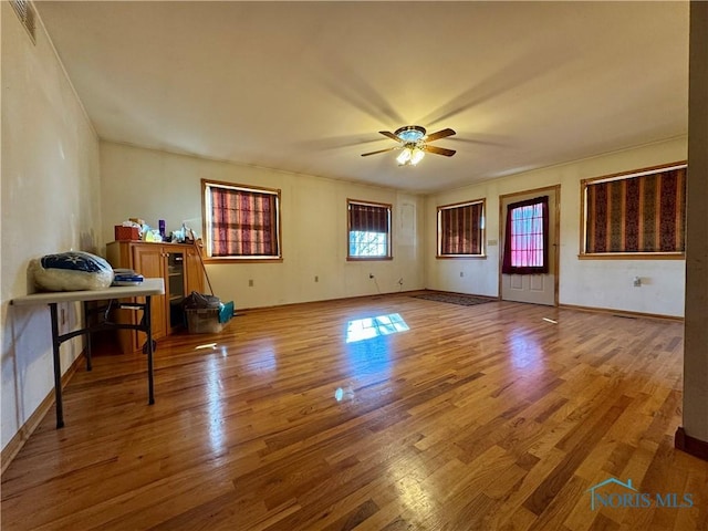 living room with ceiling fan and wood-type flooring