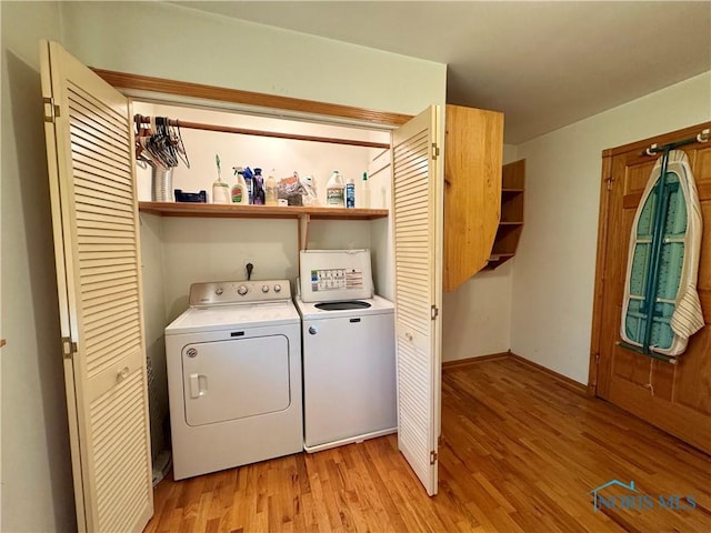 washroom featuring separate washer and dryer and light hardwood / wood-style flooring