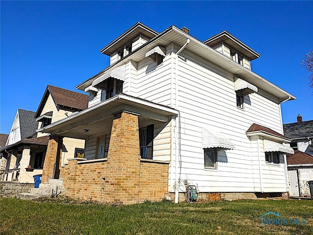 view of side of property with a lawn